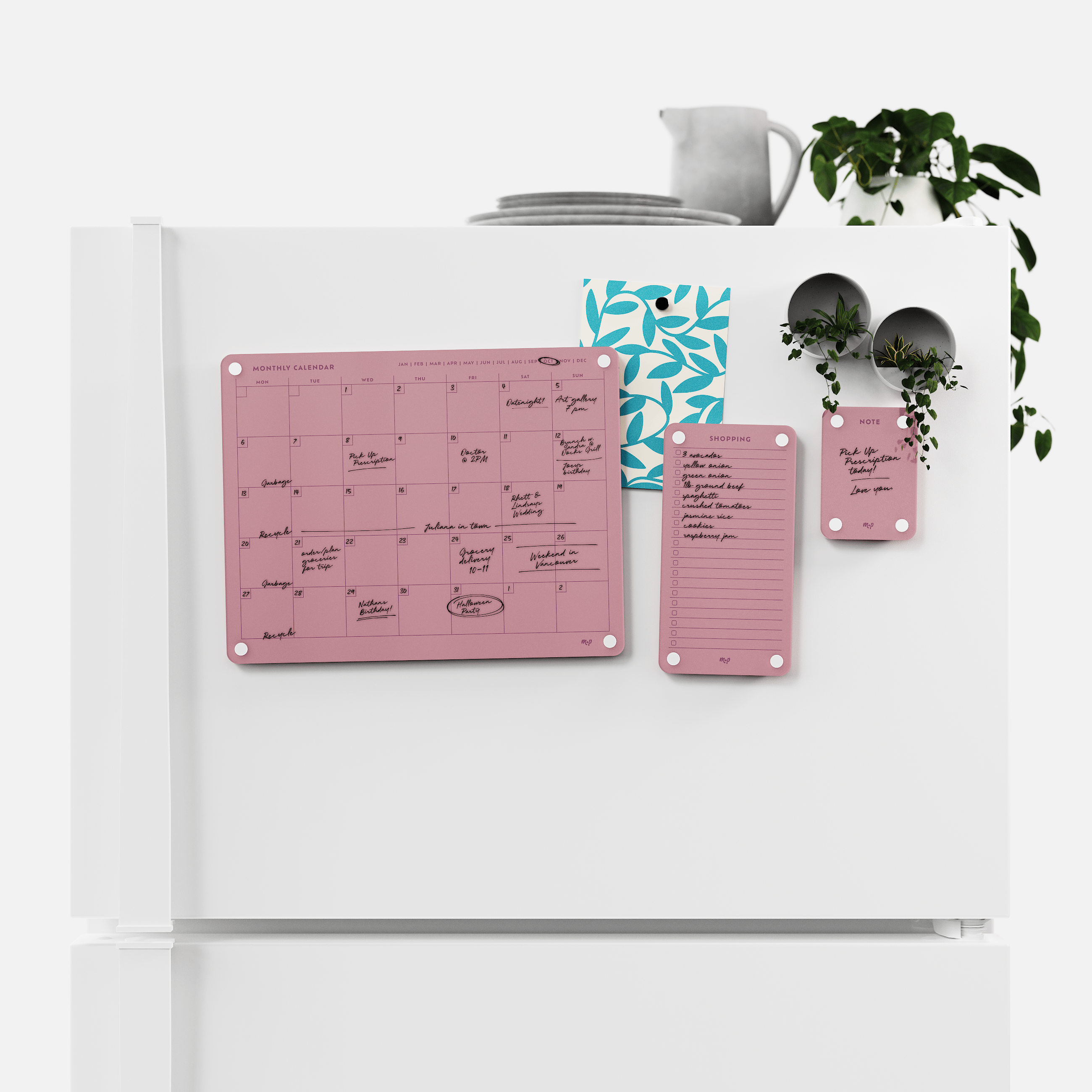 Plum monthly calendar, shopping list and note board magnetised to a white fridge door